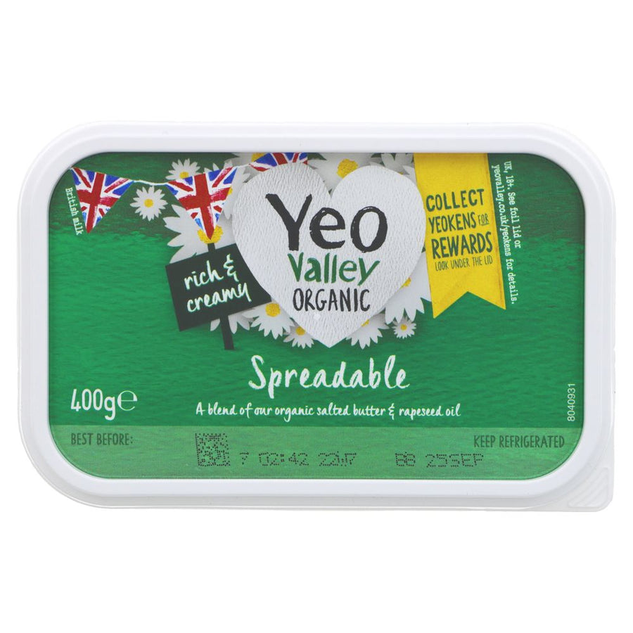 tub of yeo valley organic spreadable butter. green tub with yellow daisies